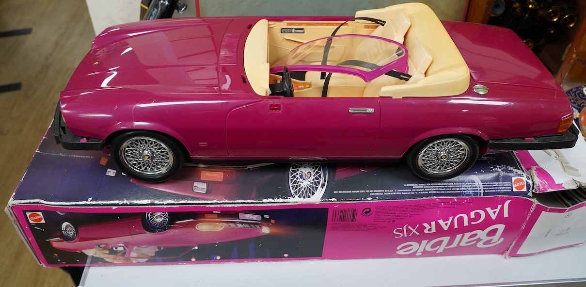 An early 1990s boxed Barbie Jaguar XJS car in pink. Condition fair to good, minor playwear and damage to the box.